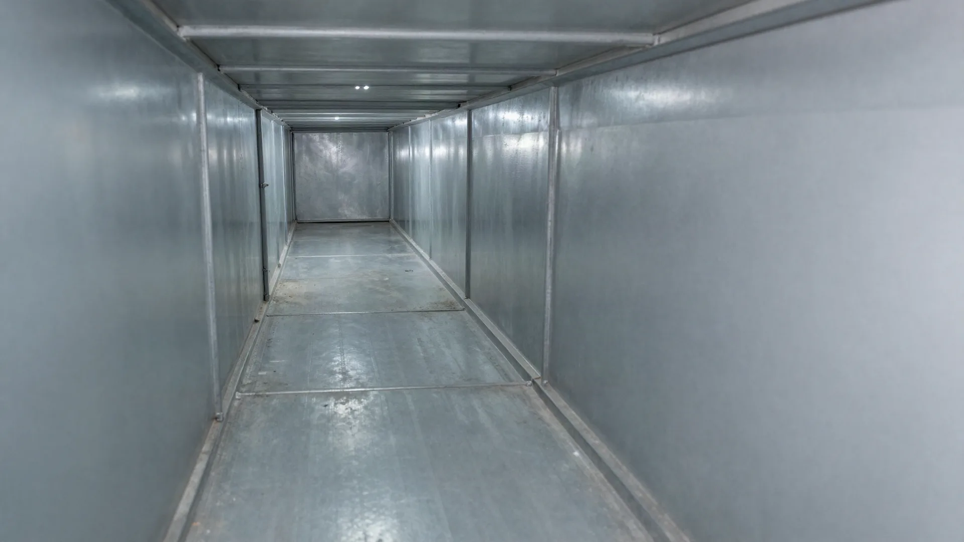A rectangular supply duct after cleaning, with bare galvanised metal walls