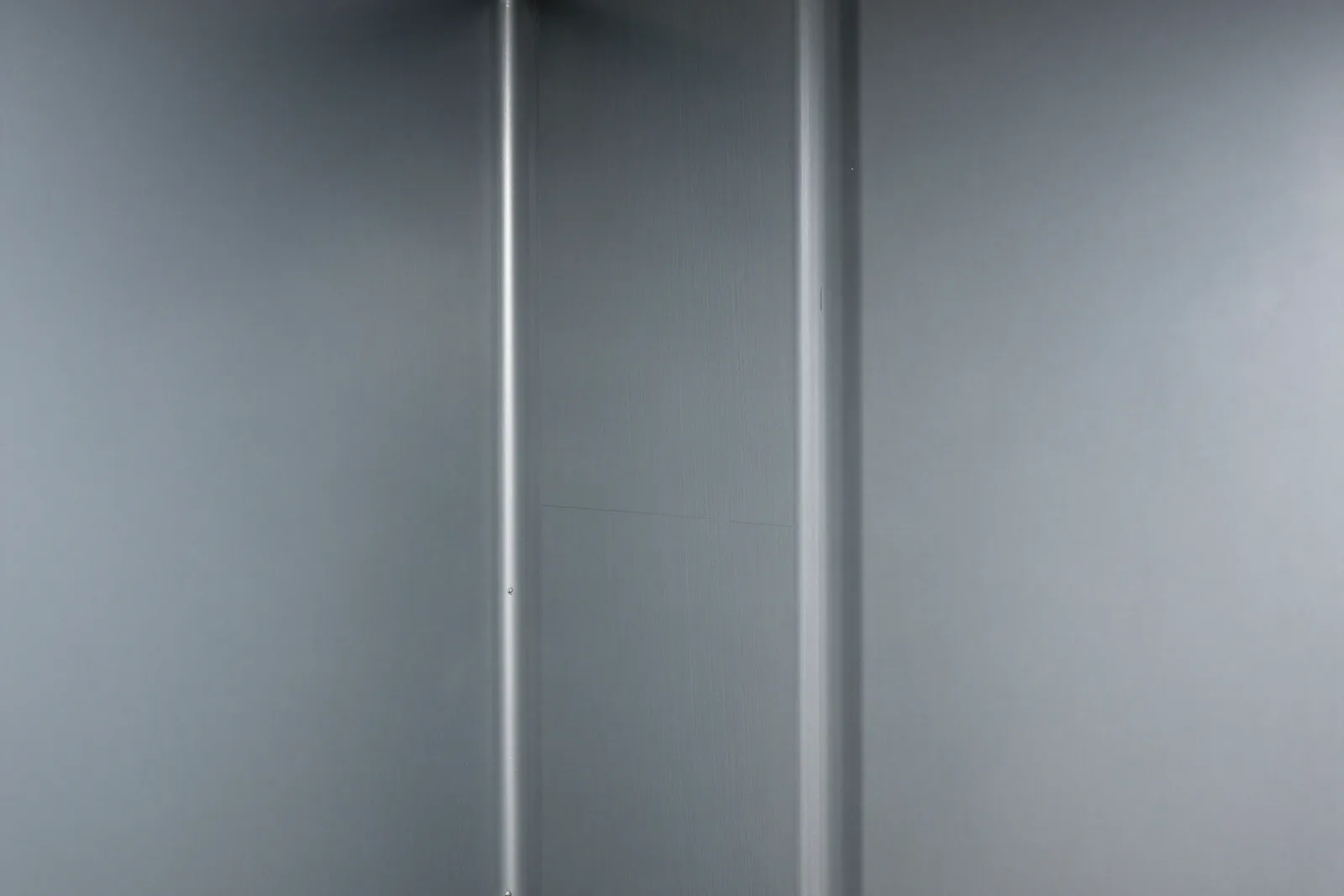 Inside a sheet metal supply duct after cleaning, with bare metal walls