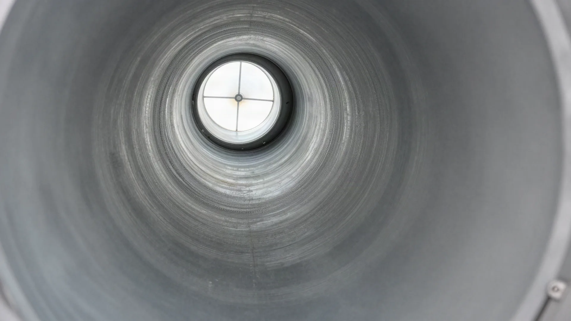 A dryer vent line after cleaning, with clear metal walls and an open path