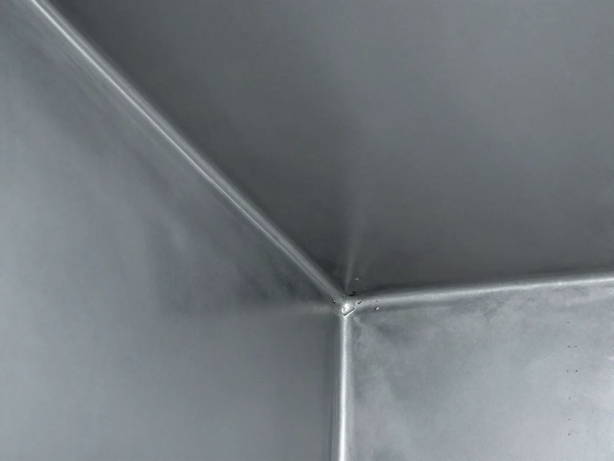 Bare metal inside a rectangular duct after cleaning